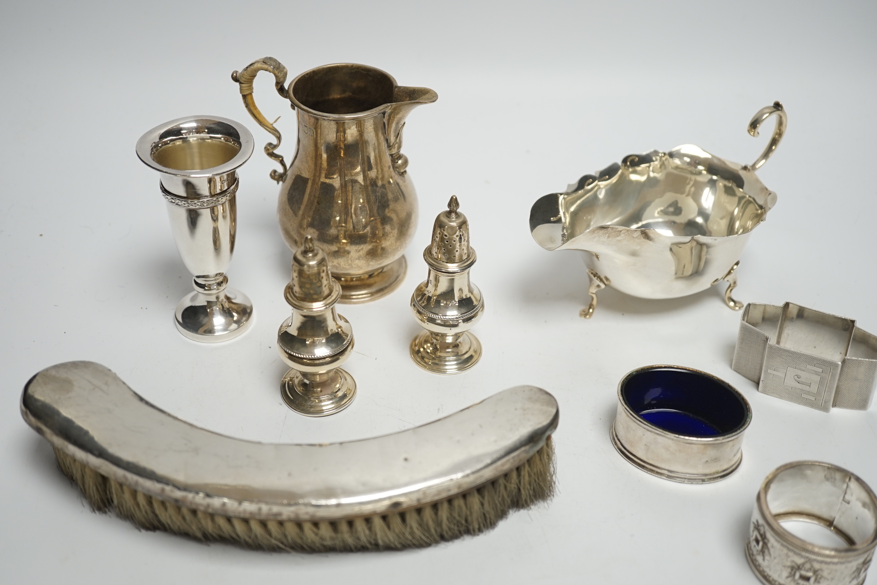 Sundry small silver including a silver sauceboat, George V sparrow beak cream jug, pair of pepperettes, napkin rings etc. and a letter opener/magnifying glass by Charles & George Asprey, London, 1908.